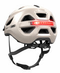 Helm ABUS Urban-I 4.0 champagne gold, schräg von hinten mit LED-Rücklicht