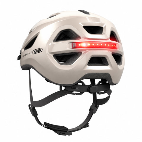 Helm ABUS Urban-I 4.0 champagne gold, schräg von hinten mit LED-Rücklicht