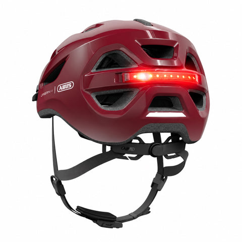 Helm ABUS Urban-I 4.0 chestnut red, schräg von hinten mit LED-Rücklicht